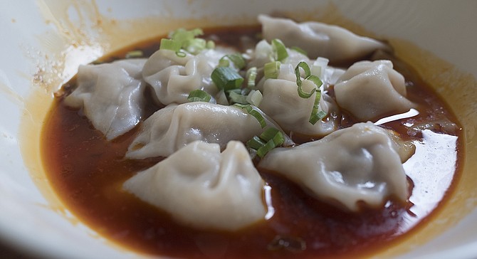 Minced pork and green onion wontons in a spicy broth