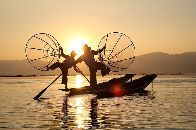 Fishermen perform a show for tourists on Lake Inle.