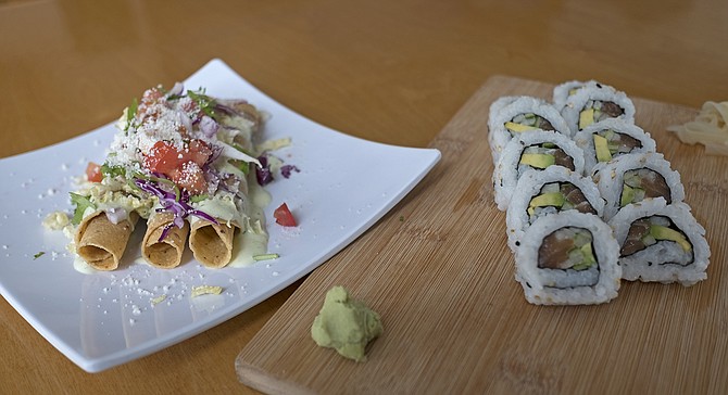 Rolled cod tacos and rolled salmon sushi, eyeing each other warily