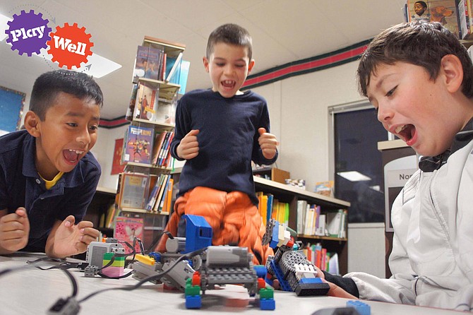 Students work on motorized LEGO projects in Play Well camp