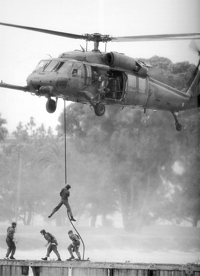 Fast-roping from a Pave Hawk version of the SH-60. "You should only have your hands in contact with the rope."