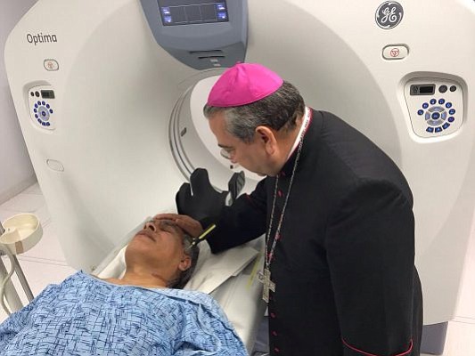 Archbishop Francisco Moreno at hospital with Father Zambrano.