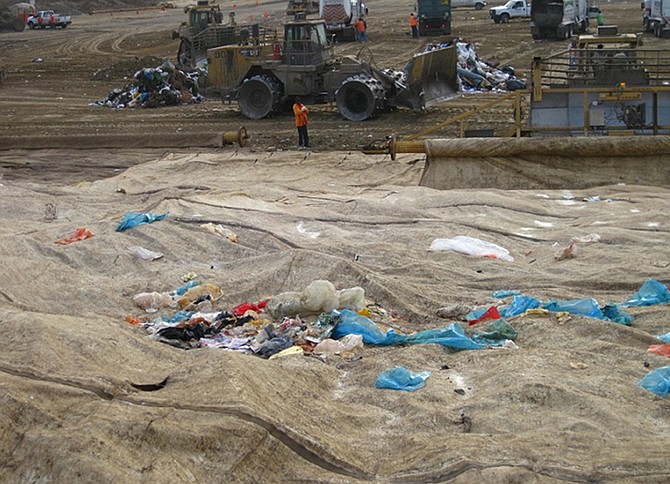 2011 inspection showed waste on top of tarps and green material not compacted. 
