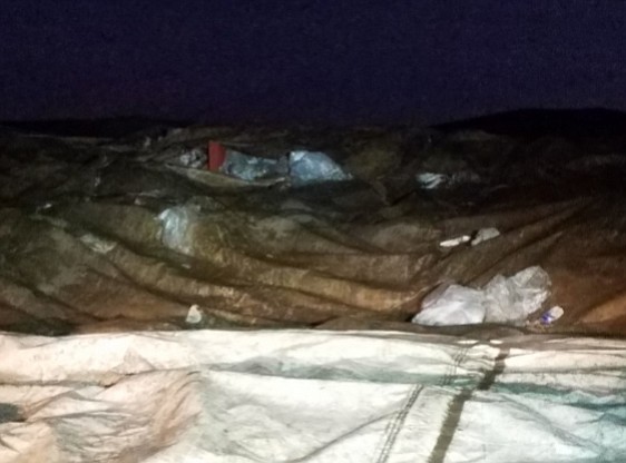 In October 2016, an inspection showed exposed waste outside of and on top of the tarp. 