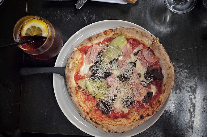 The Sofia Pizza with mozzarella, mushrooms, artichoke, and prosciutto cotto.