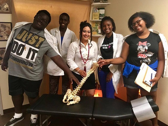 Dr. Cat Teaching Young Teens on the Benefits of Chiropractic Care for Health Improvement, Maintenance and Prevention