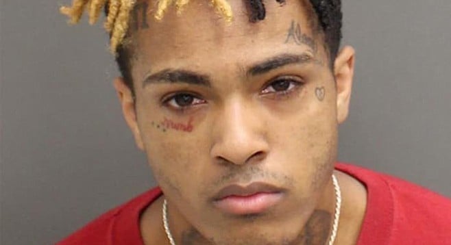 Mugshot of XXXtentacion (that's a red tattoo under his right eye)