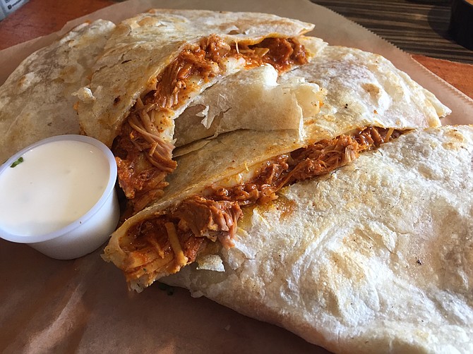 The "more flavorful than thou" quesadilla with the "House Special," or cochinitas pibil. 