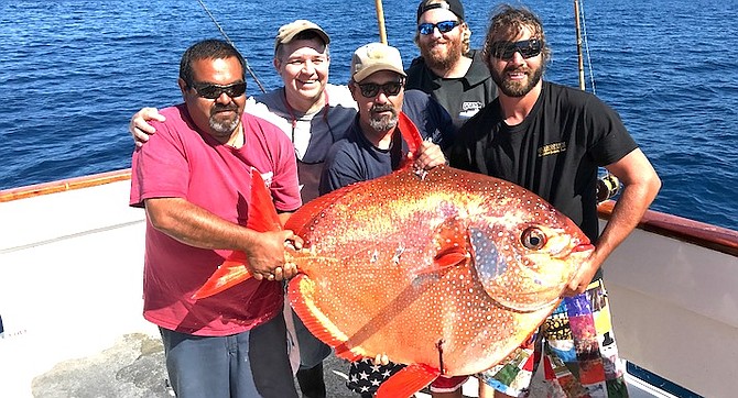 The beautifully-colored discus-shaped opah ate a flat-fall jig on 60-pound test line.