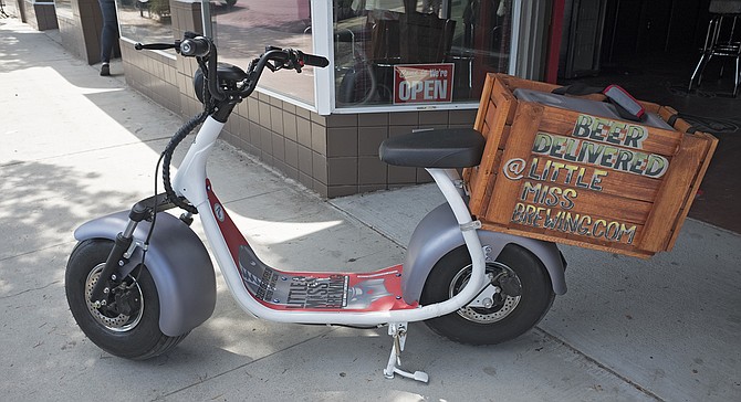 Little Miss Brewing's electric scooter delivers growlers within 2.5 miles of its Normal Heights tasting room.