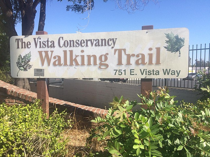 The Vista Conservancy Walking Trail park is near a busy road.