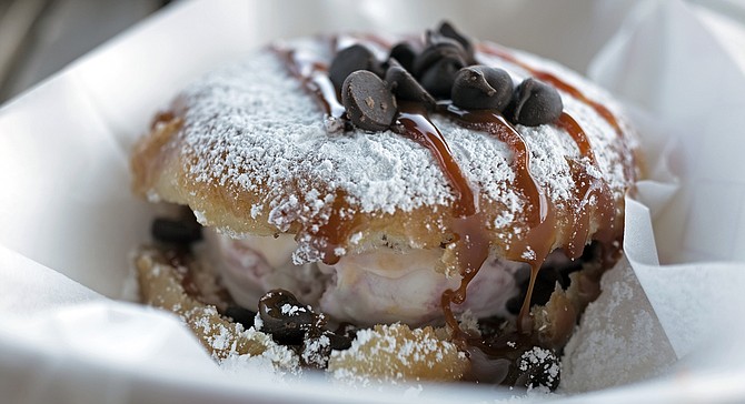 Raspberry white-chocolate ice cream sandwiched in a glazed donut topped with chocolate chips and cajeta