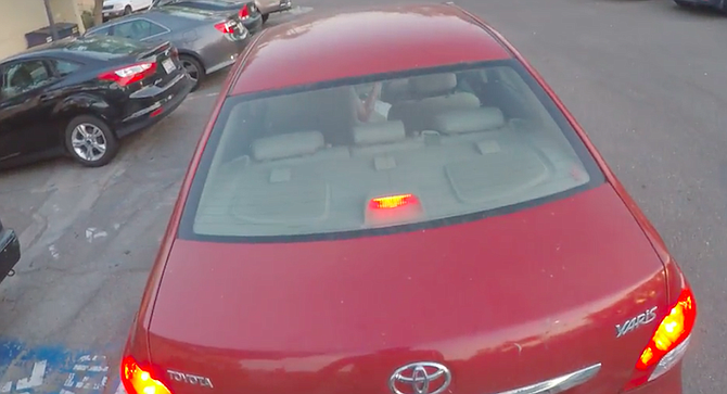The video starts with the cyclist pursuing the red car as it heads east on Adams Avenue.