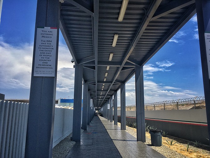 A long open hallway follows the Tijuana river, directly underneath the bridge that connects to PedWest.