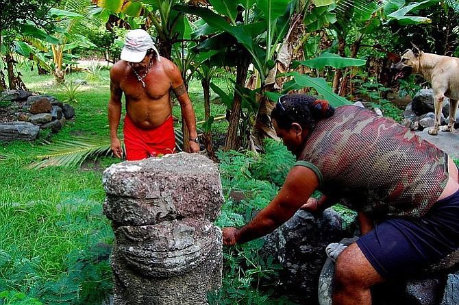 From left to right: Harris, Romain and Ganja inspect the large stone tiki at Hakamoui, Ua Pou.