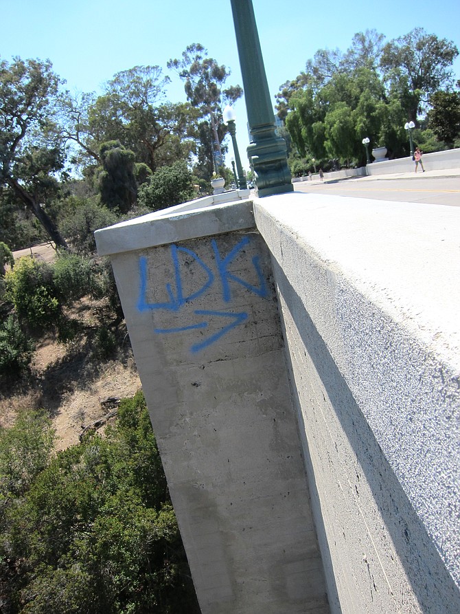 Graffiti was seen all over the bridge. This "LDK" has an arrow pointing to other side of the bridge where I saw homeless people exiting the deck. 