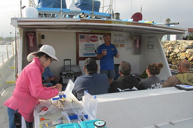 Volunteer anglers listen to fish data collection instructions by Capt. Joe Cacciola. 