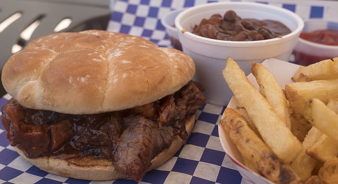 A meal of brisket sandwich, fries, and baked beans at Smokin' Blaine's BBQ.