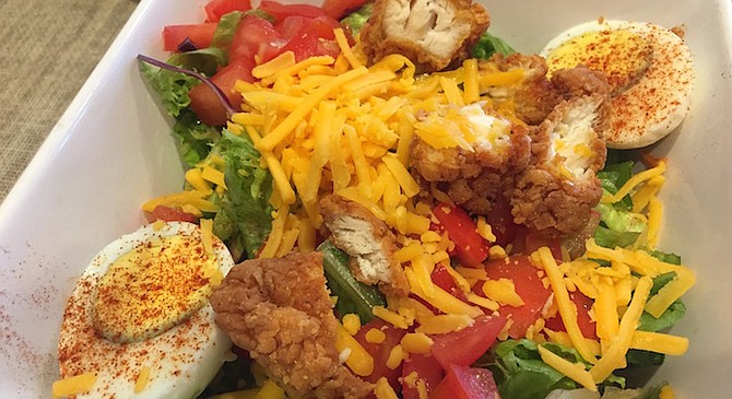Simple cheddar, hunks of ripe tomatoes on greens, served with a hardboiled egg, and of course the fried chicken.