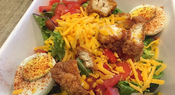 Simple cheddar, hunks of ripe tomatoes on greens, served with a hardboiled egg, and of course the fried chicken. 