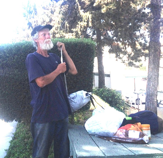 On July 27, a neighbor told me a homeless guy was hiding in the bushes near my residence — he was making a sandwich when I approached.