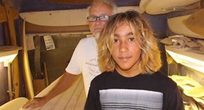 13-year-old Zach Flores with master shaper Jim Phillips in Phillips' Encinitas shaping room.