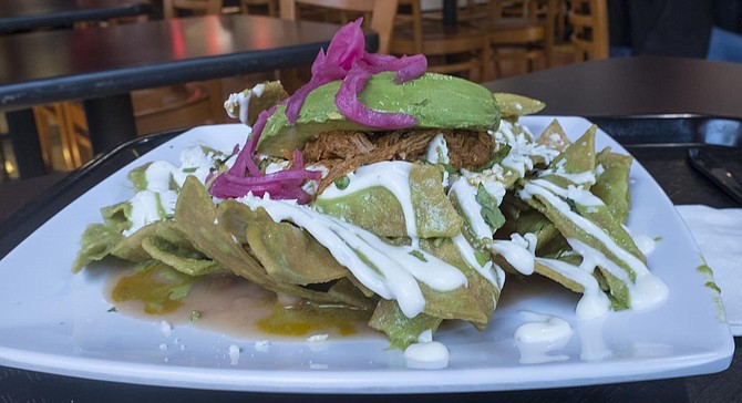 Avocados and pickled onions add color to La bomba chilaquiles.