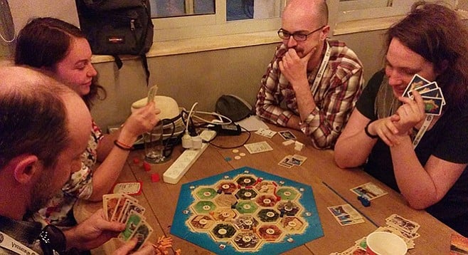 Adults playing Catan without irony