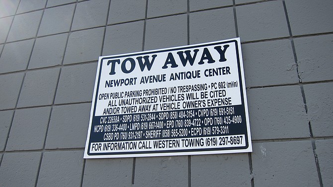 At the Antique Center, most of the "tow away" signs are now sans any mention of South Beach. 