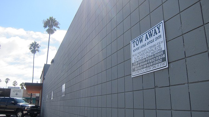 New "tow away" signs at Antique Center make no mention of South Beach. 
