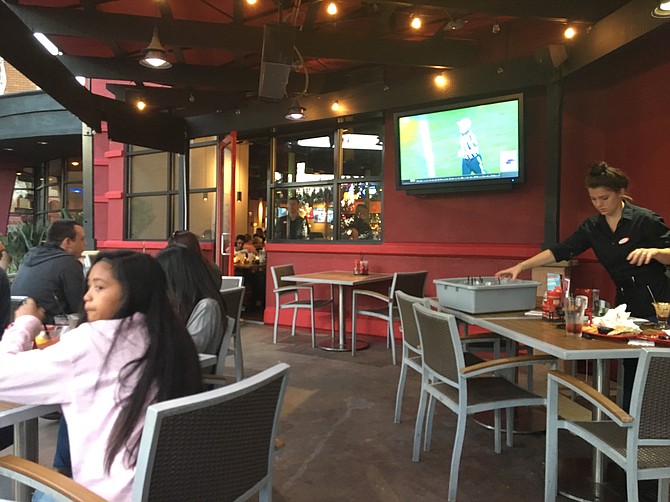 The patio area has heat lamps, a TV and an overworked waitress.