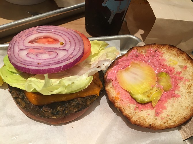 The Rescued Veggie Burger has lettuce, tomato, red onion, pickles and a 1000 island dressing made with beets.