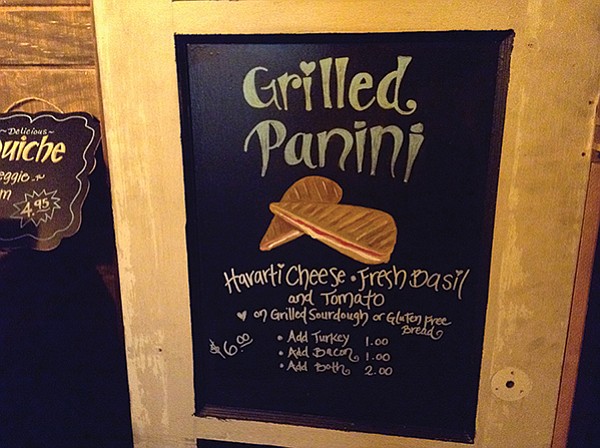 I look around for some menu, but the only thing I spot is this wall sign.