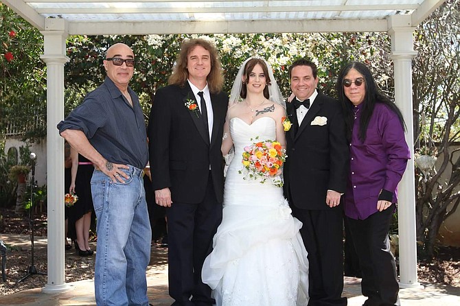 At Joe and Rachel Troutman’s 2015 wedding: Green Jello lead singer Bill Manspeaker (who performed), Megadeth bassist David Ellefson (who officiated), Rachel, Joe, and “wedding singer” James Rivera of Helstar.