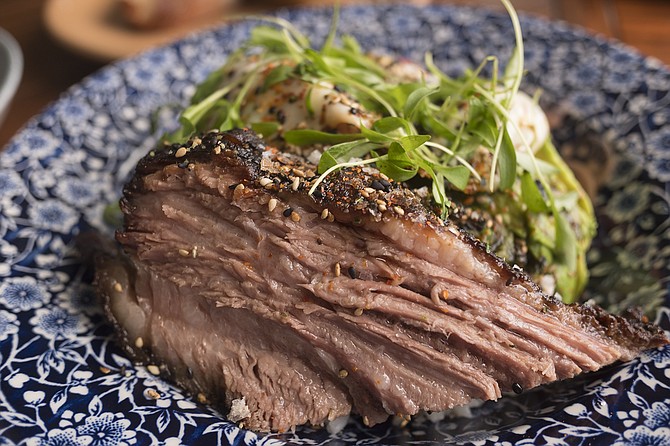Red eye rubbed brisket, served over rice with fried egg, avocado, microgreens, chimmichurri, and pickled radish.