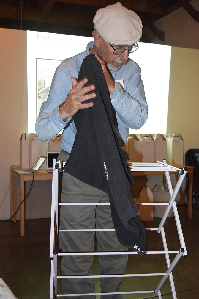 Paul Hormick demonstrates a home clothes drying rack.