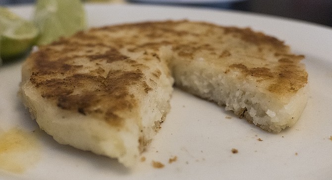 The arepa, a cheesy cornmeal pancake.