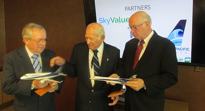 California Pacific Airlines' COO Paul Hook, founder Ted Vallas, and CEO Darrell Richardson show off models of the Embraer jets they recently purchased.