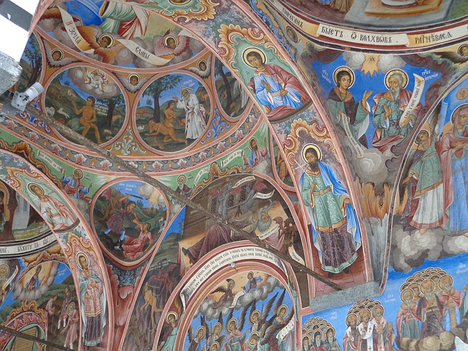 Vibrant murals under the portico of the church at Rila Monastery