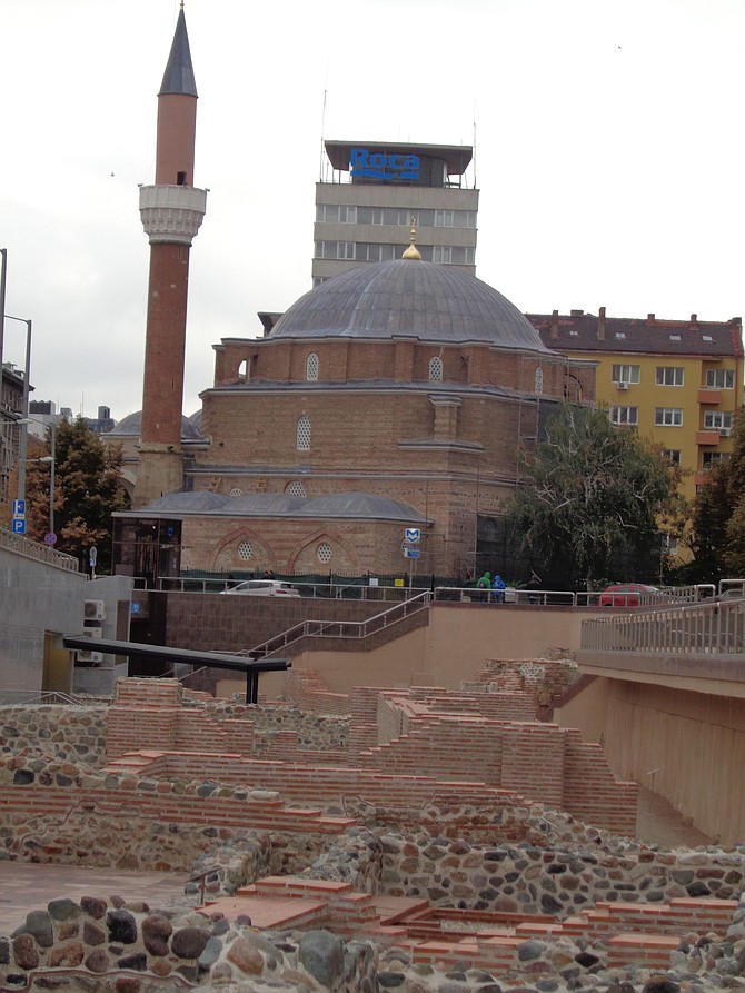 Modern buildings and old mosque above ancient Roman ruins at the Serdika Metro station.