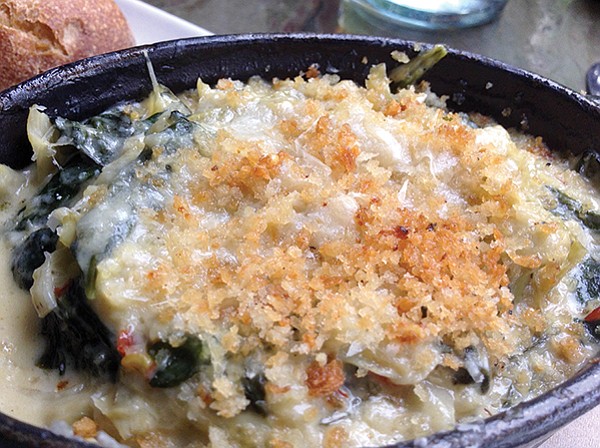 A baked artichoke and spinach cassoulet, with parmesan cheese inside and breadcrumbs on top.