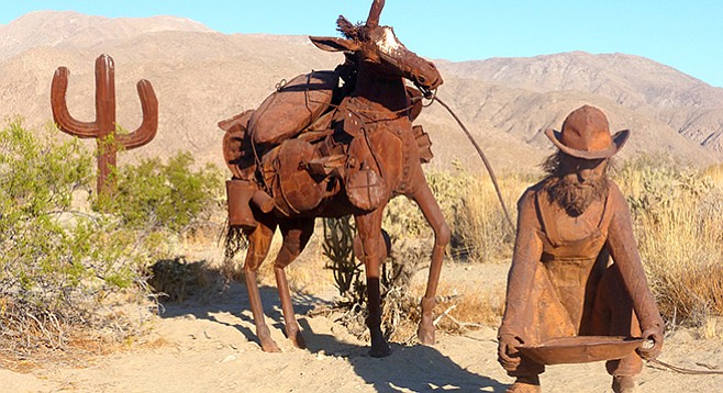 Prospector and mule now near the saguaro