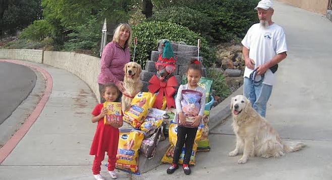 Janet Mika (left, with Frankie) and Rick Albin (right, with Clancy) welcomed donations from Danielle and Angelique.