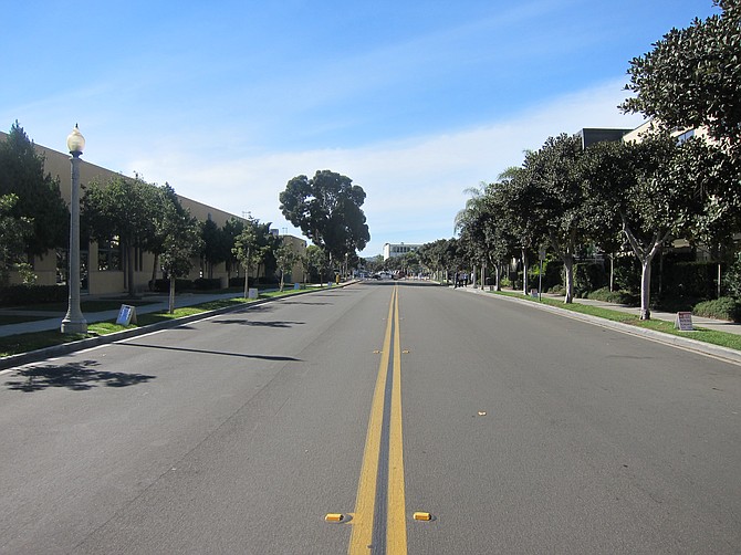 This street is jam packed with cars during the week. It's closed off for weekend church service. (High Tech High to the left, Rock Church to the right).