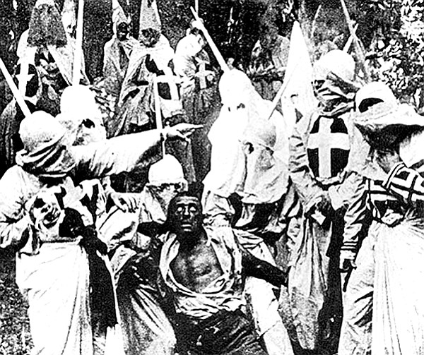 Hooded Klansmen catch Gus, portrayed in blackface by actor Walter Long in The Birth of a Nation.