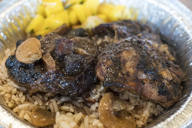 Jerk chicken (right) and oxtail (with a butter bean on top), with mangos.