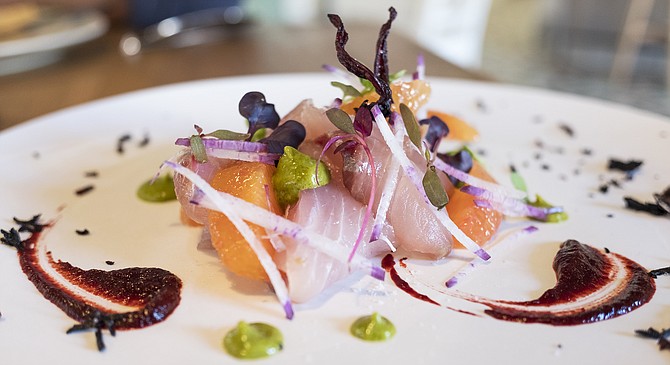 A hibiscus and smoked chili coulis, plus crispy hibiscus flowers, dress a yellowtail tiradito