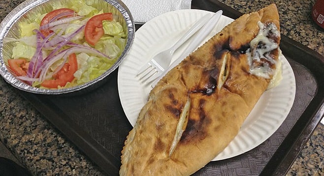 The calzone looks straight out of rustic Italy.