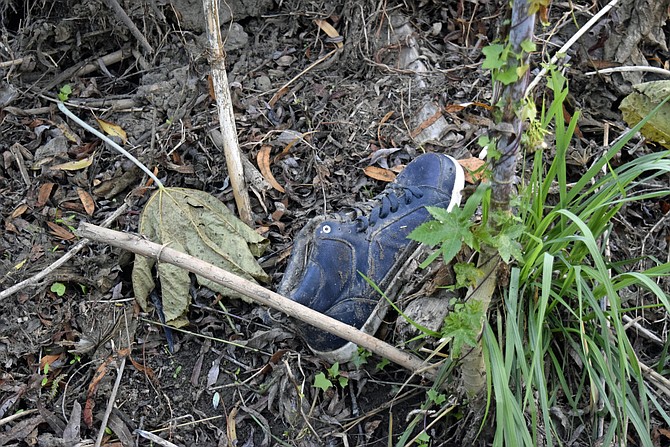 A discarded shoe in the San Diego River bed.