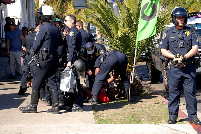 A man was taken down by several policemen.